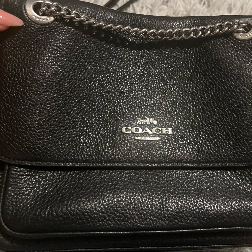 Black Coach pebble leather fold over flap purse.